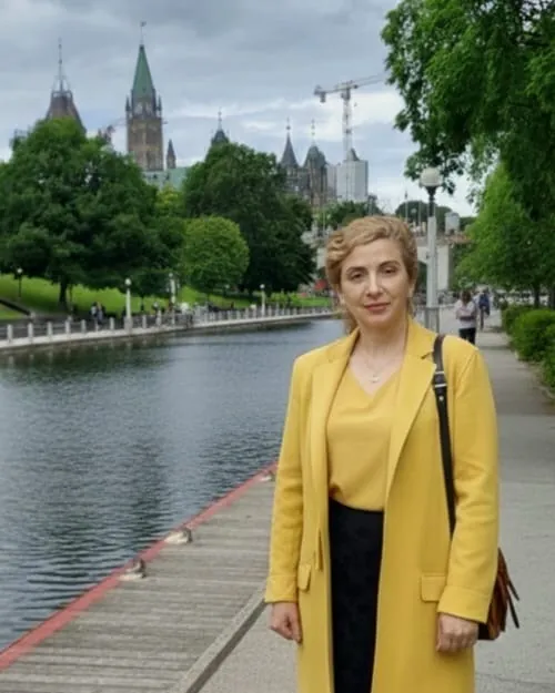 Dr. Leila Okhravi standing by the Rideau Canal in Ottawa